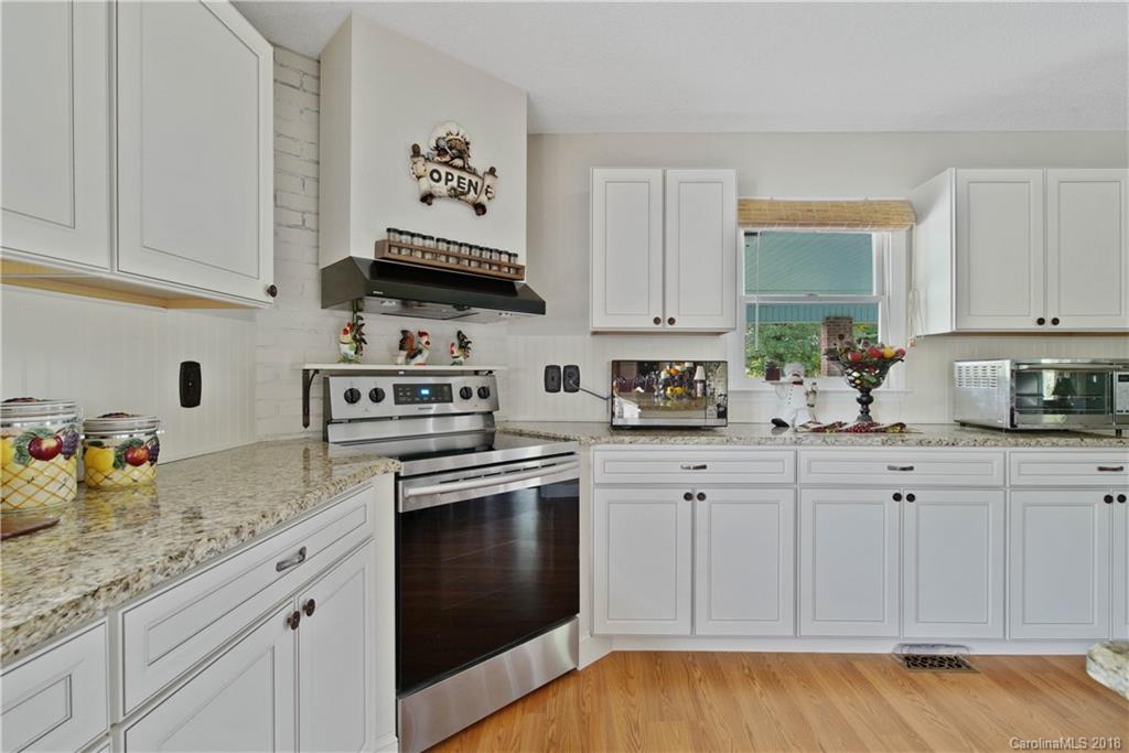 1948 Kadena Lane York, SC 29745 - Photo 11 of 25 a kitchen with granite countertop white cabinets and stainless steel appliances