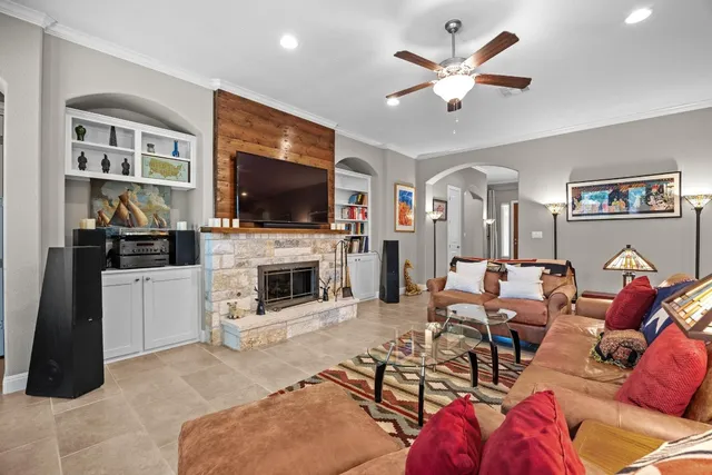 a living room with furniture a flat screen tv and a fireplace