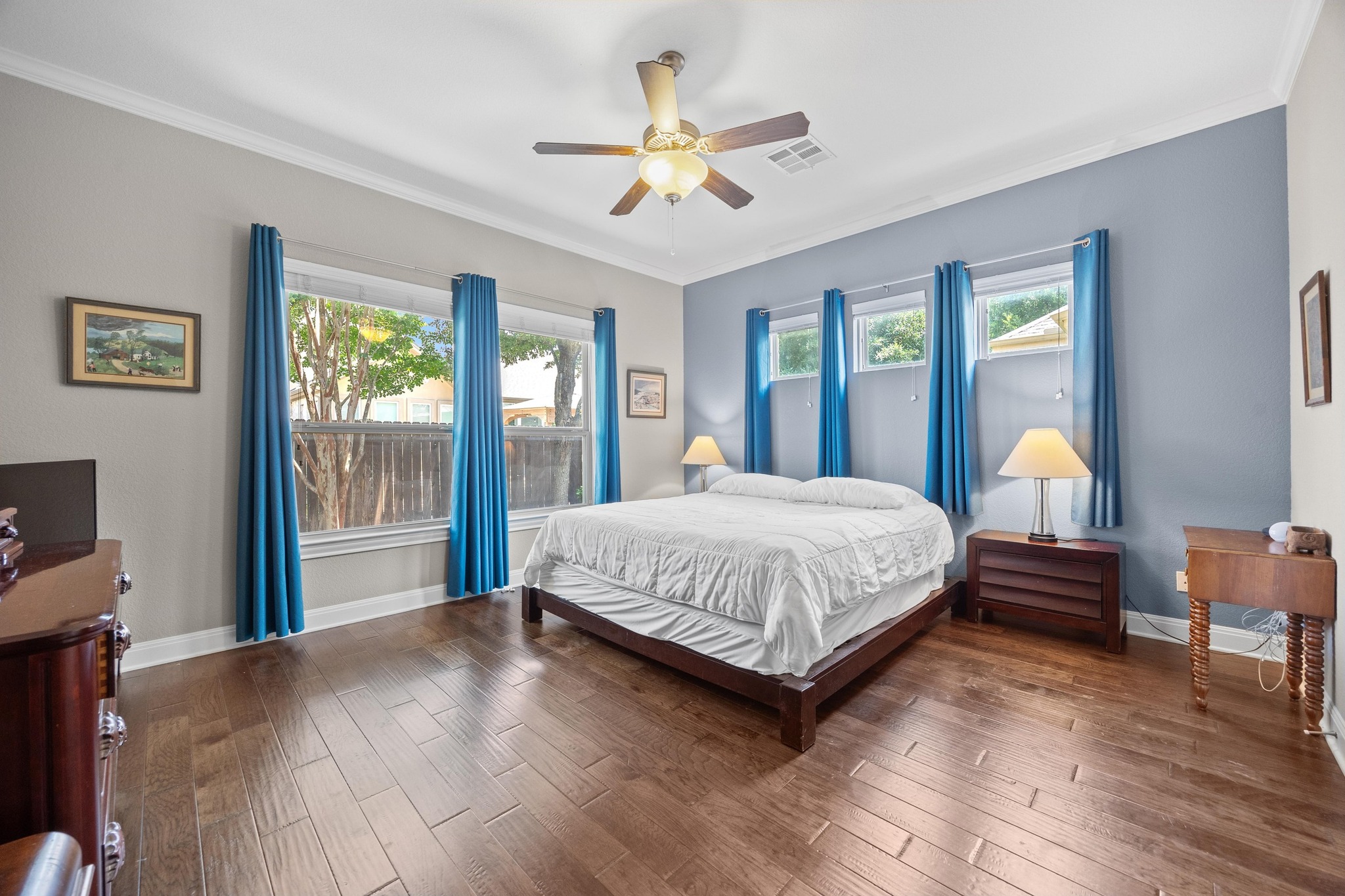 2114 Manada Trail Leander, TX 78641 - Photo 18 of 36 a bedroom with a bed and a chandelier