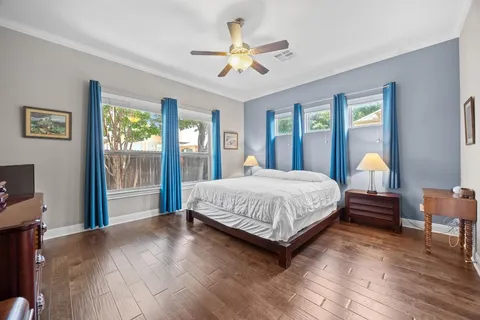 a bedroom with a bed and a chandelier
