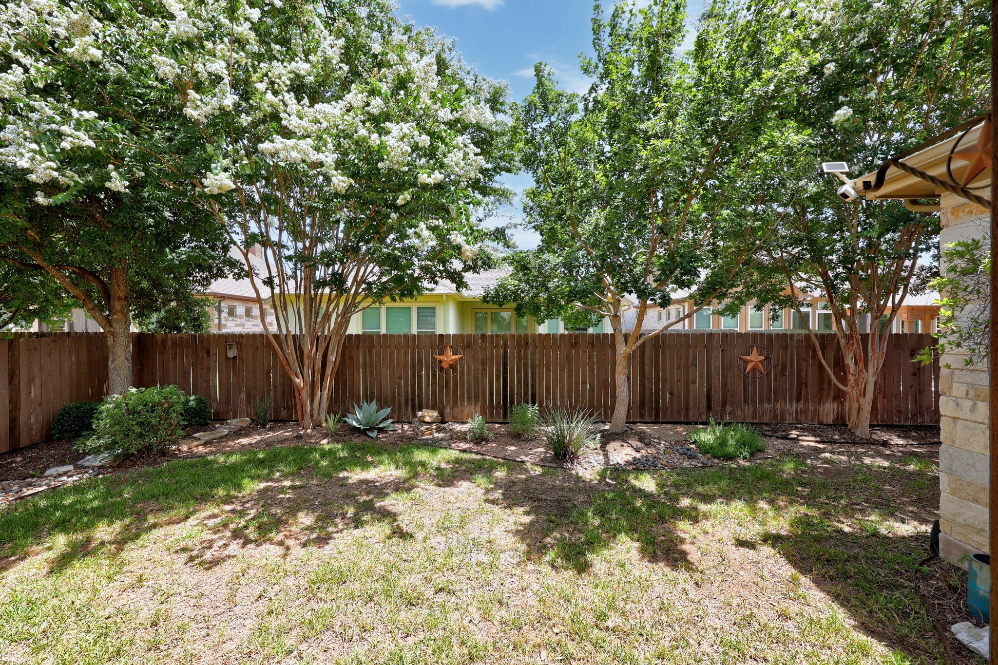 2114 Manada Trail Cedar Park, TX 78641 - Photo 24 of 36 a view of a backyard with large trees and wooden fence