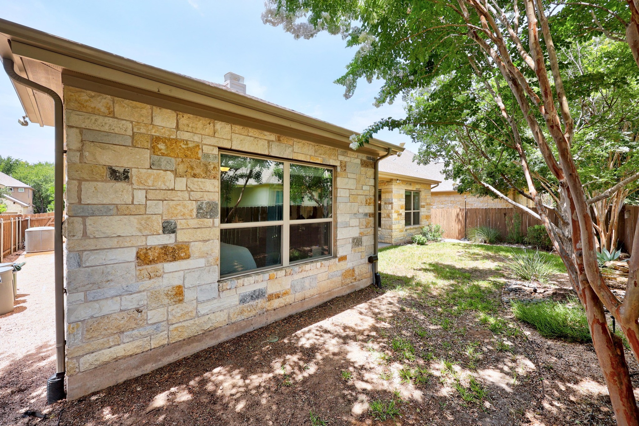 2114 Manada Trail Cedar Park, TX 78641 - Photo 25 of 36 a view of a house with a large window and wooden fence