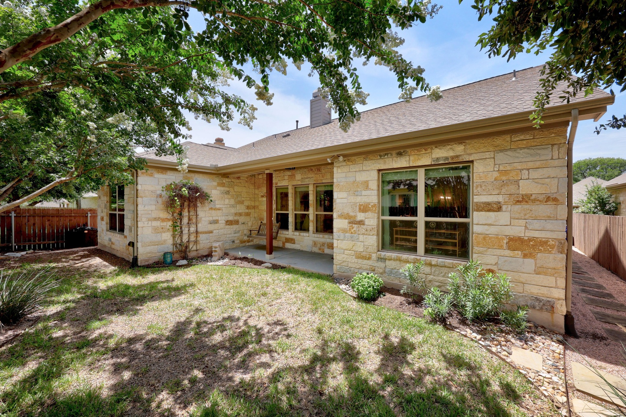 2114 Manada Trail Leander, TX 78641 - Photo 29 of 36 a view of a house with a large window and potted plants