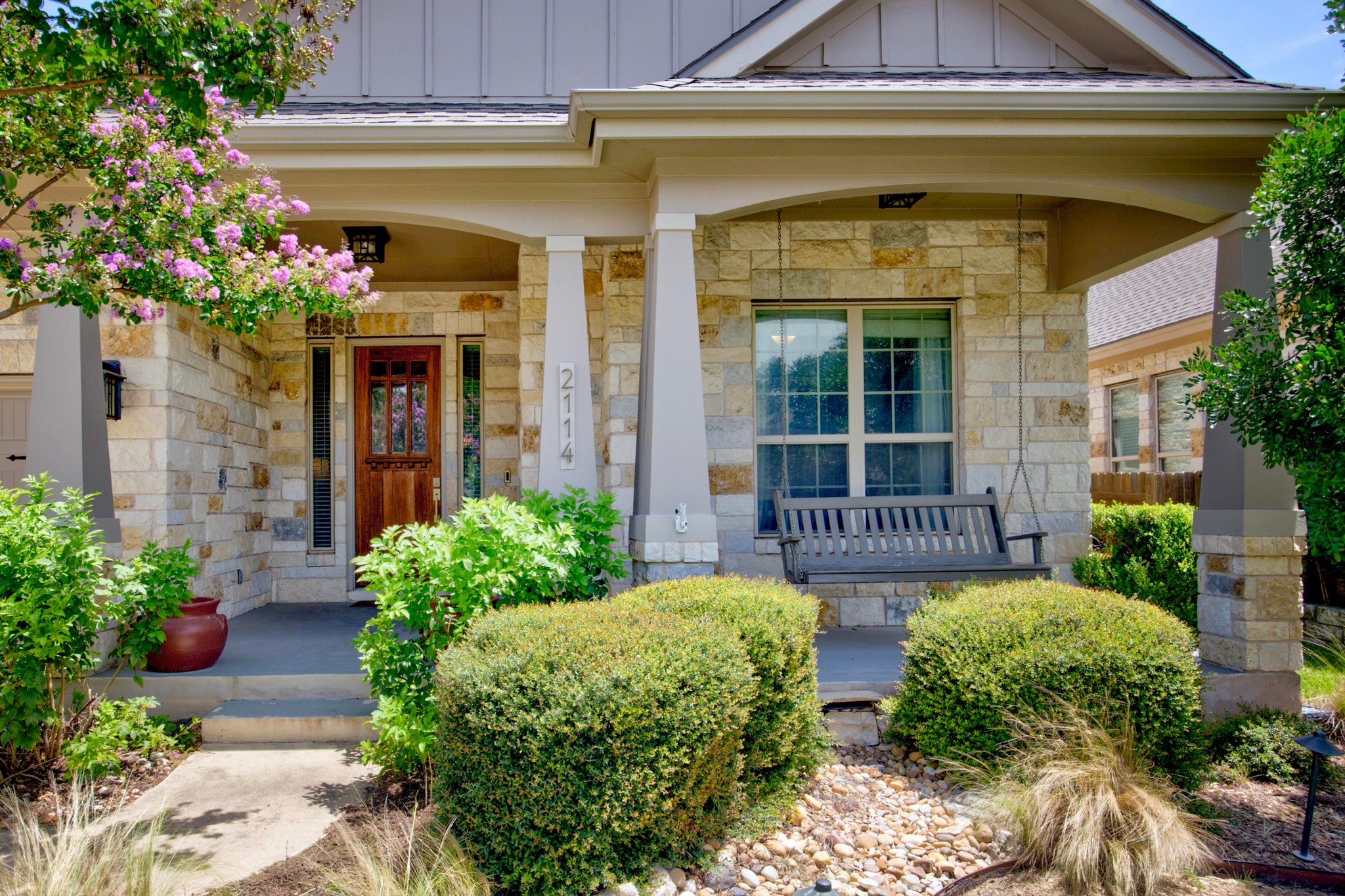 2114 Manada Trail Leander, TX 78641 - Photo 4 of 36 a view of a house with potted plants and a table and chairs