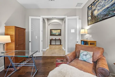 a living room with furniture and wooden floor