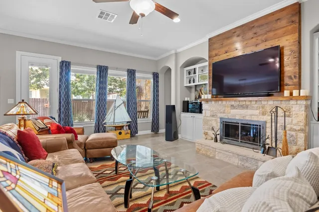 a living room with furniture a flat screen tv and a fireplace