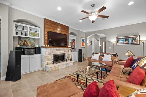 a living room with furniture a flat screen tv and a fireplace