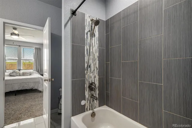 a bathroom with a tub and shower