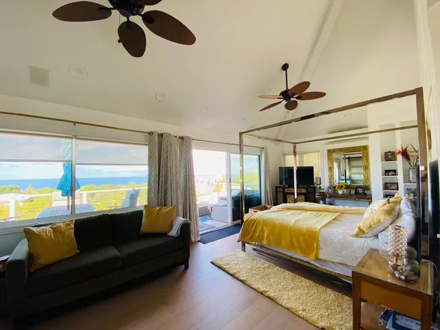 a bedroom with a bed window and couch