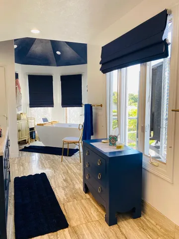 a living room with a large window and a flat screen tv