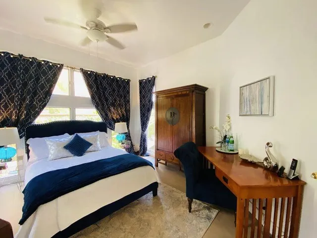 a bedroom with furniture and a window