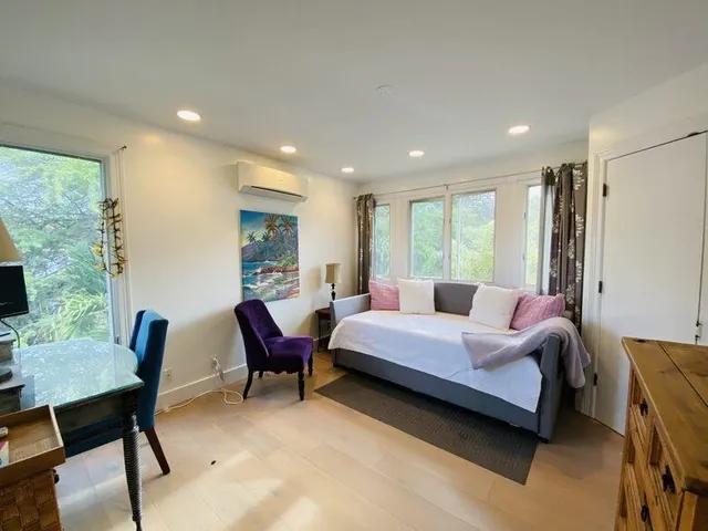 a bedroom with a bed a desk and chair