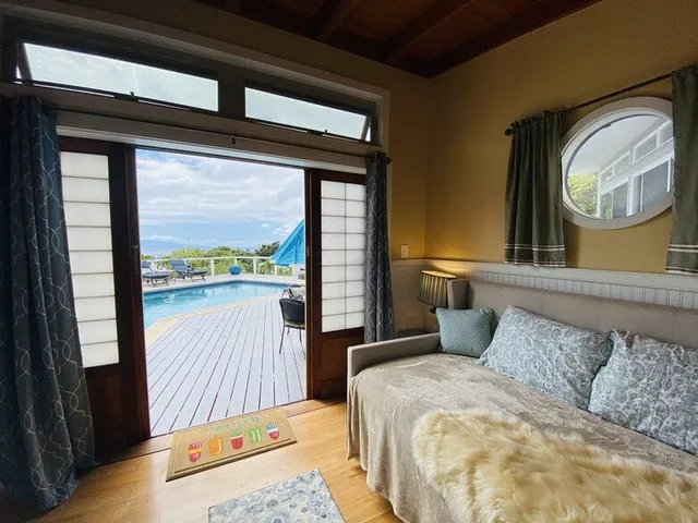 a bedroom with a large bed and a large window