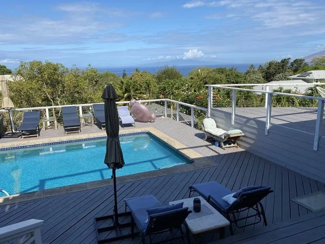 a view of a balcony with chair and wooden floor