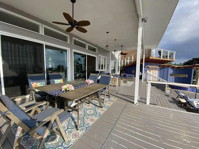 a view of a patio with table and chairs with wooden floor and floor to ceiling window