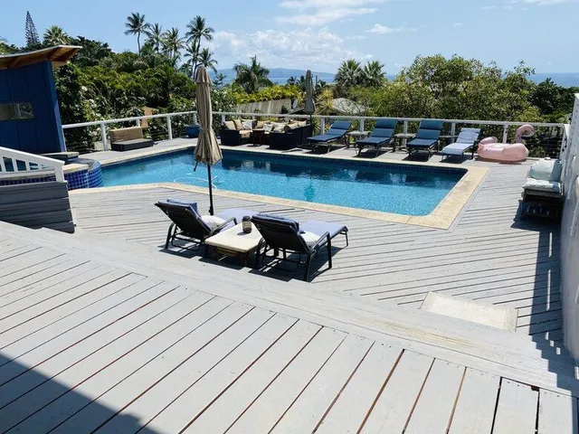a view of a roof deck with wooden floor and seating space