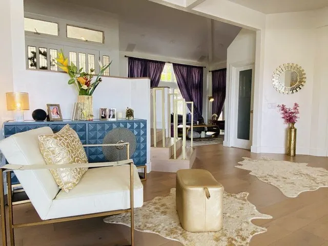 a living room with furniture and wooden floor