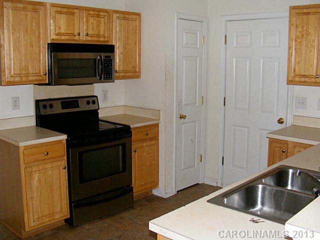 831 Valley Ridge Road Charlotte, NC 28214 - Photo 2 of 12 a kitchen with a sink stove and microwave