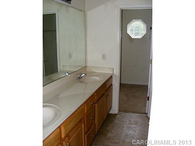 831 Valley Ridge Road Charlotte, NC 28214 - Photo 6 of 12 a bathroom with a sink and a mirror