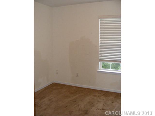 831 Valley Ridge Road Charlotte, NC 28214 - Photo 7 of 12 a view of an empty room with a window