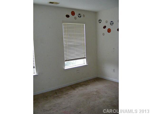831 Valley Ridge Road Charlotte, NC 28214 - Photo 8 of 12 a view of an empty room with a window