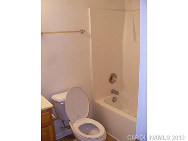 831 Valley Ridge Road Charlotte, NC 28214 - Photo 9 of 12 a white toilet sitting next to a bath tub