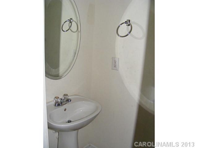 831 Valley Ridge Road Charlotte, NC 28214 - Photo 10 of 12 a bathroom with a sink and mirror