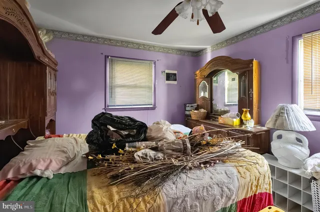 a bedroom with furniture and a large window