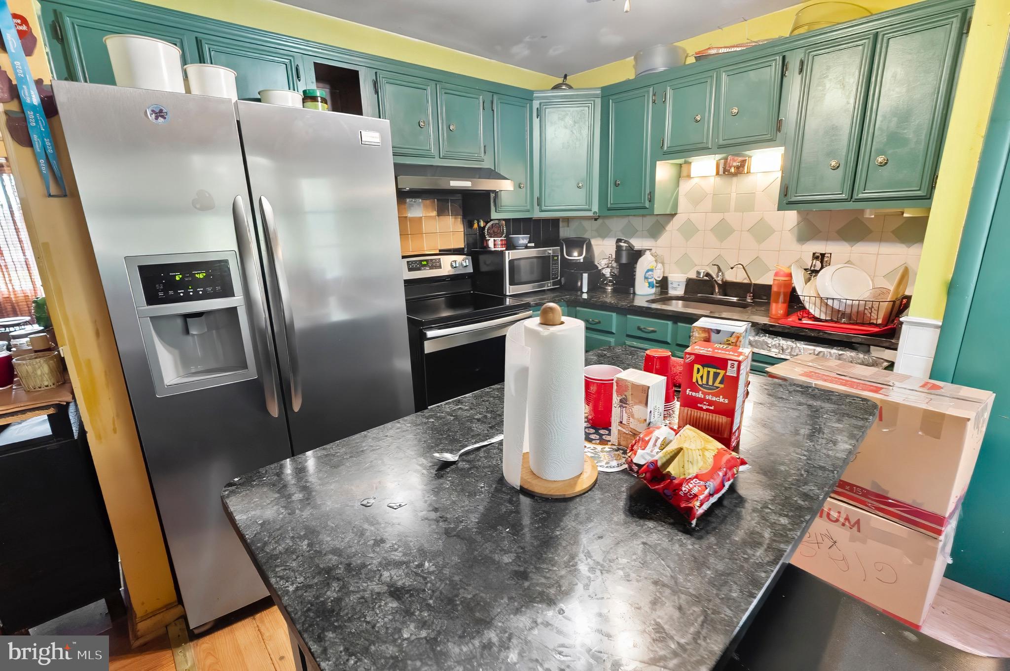 1715 Walker Road Freeland, MD 21053 - Photo 25 of 31 a kitchen with stainless steel appliances granite countertop a refrigerator and a stove top oven