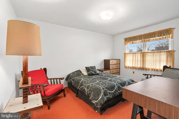 a bedroom with two beds and a window