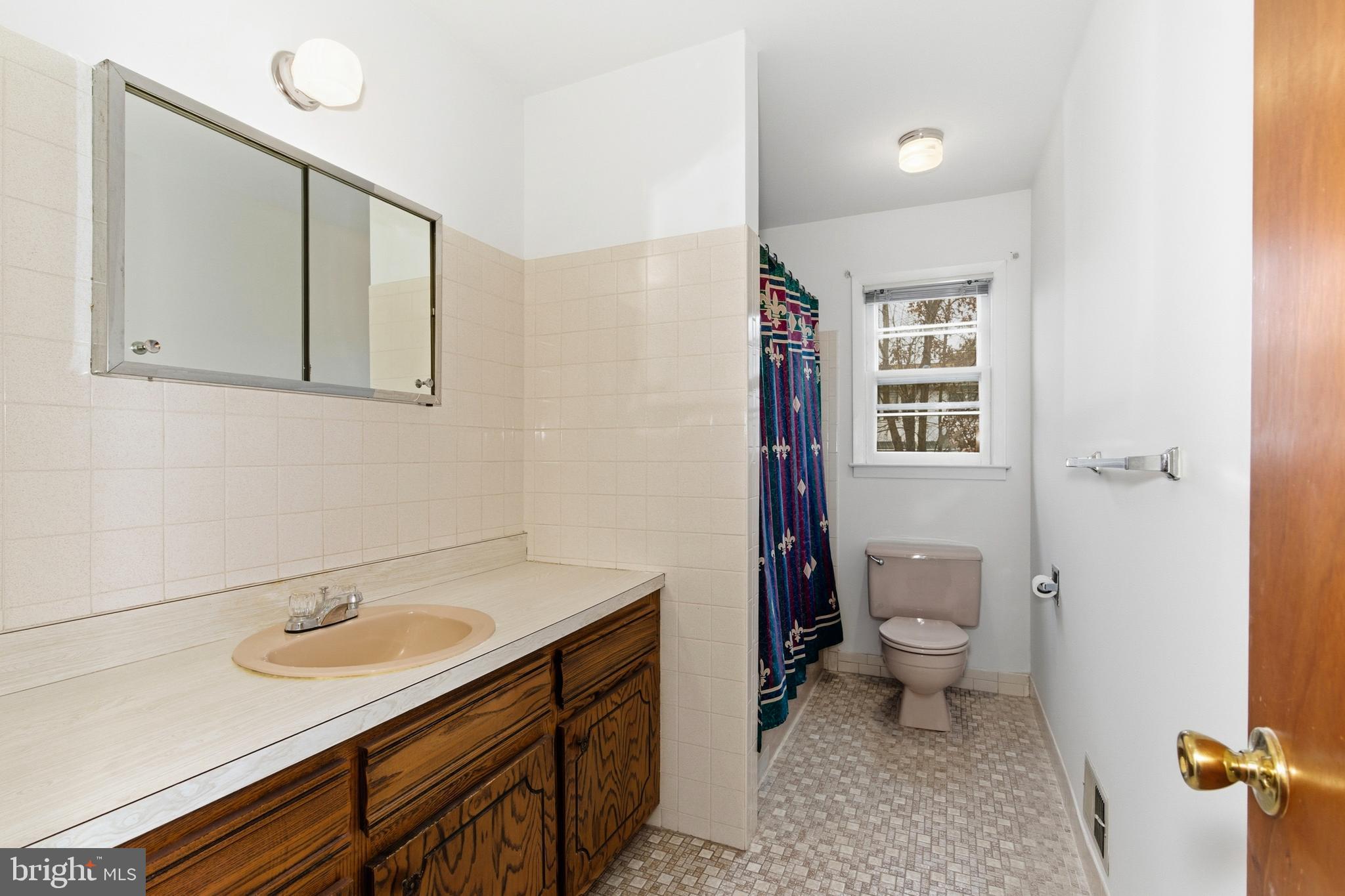 4 David Drive Ewing, NJ 08638 - Photo 22 of 32 a bathroom with a sink a toilet and a mirror