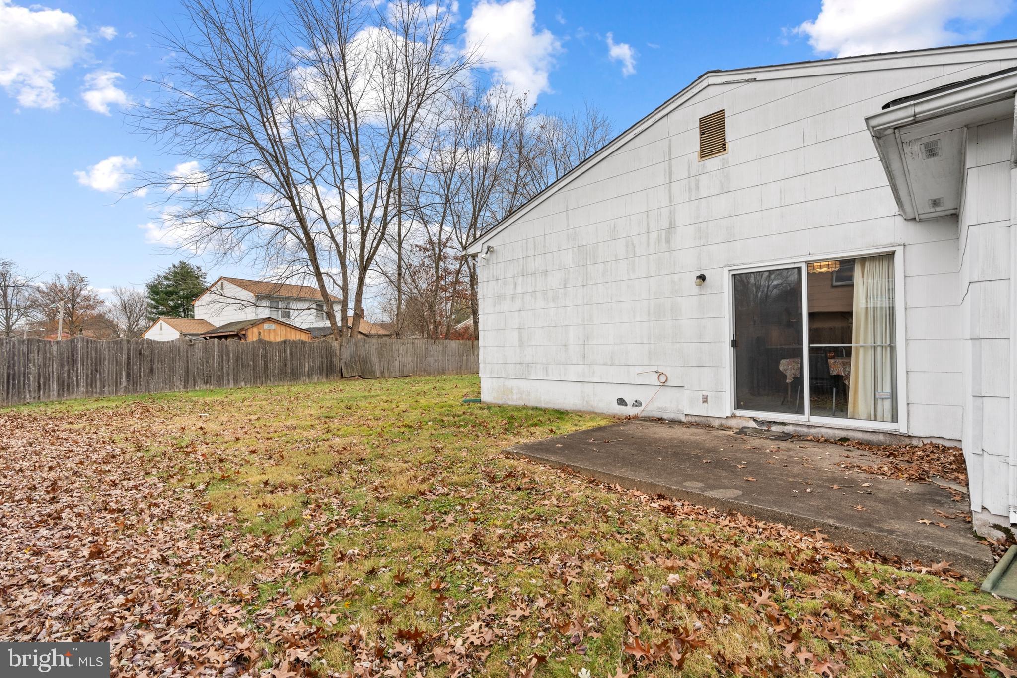 4 David Drive Ewing, NJ 08638 - Photo 25 of 32 a backyard of a house with large trees and covered with wooden fence