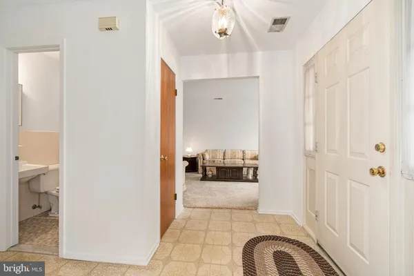 a view of living room and kitchen with a sink
