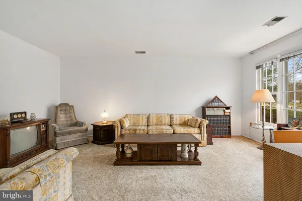 a bedroom with furniture and natural light