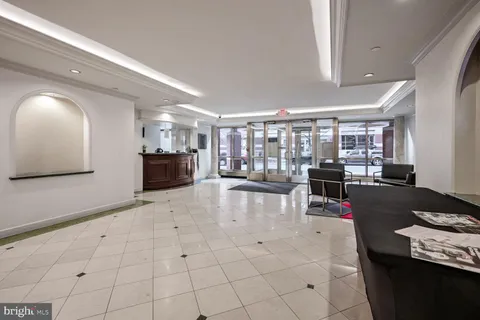 a lobby with furniture and view of kitchen