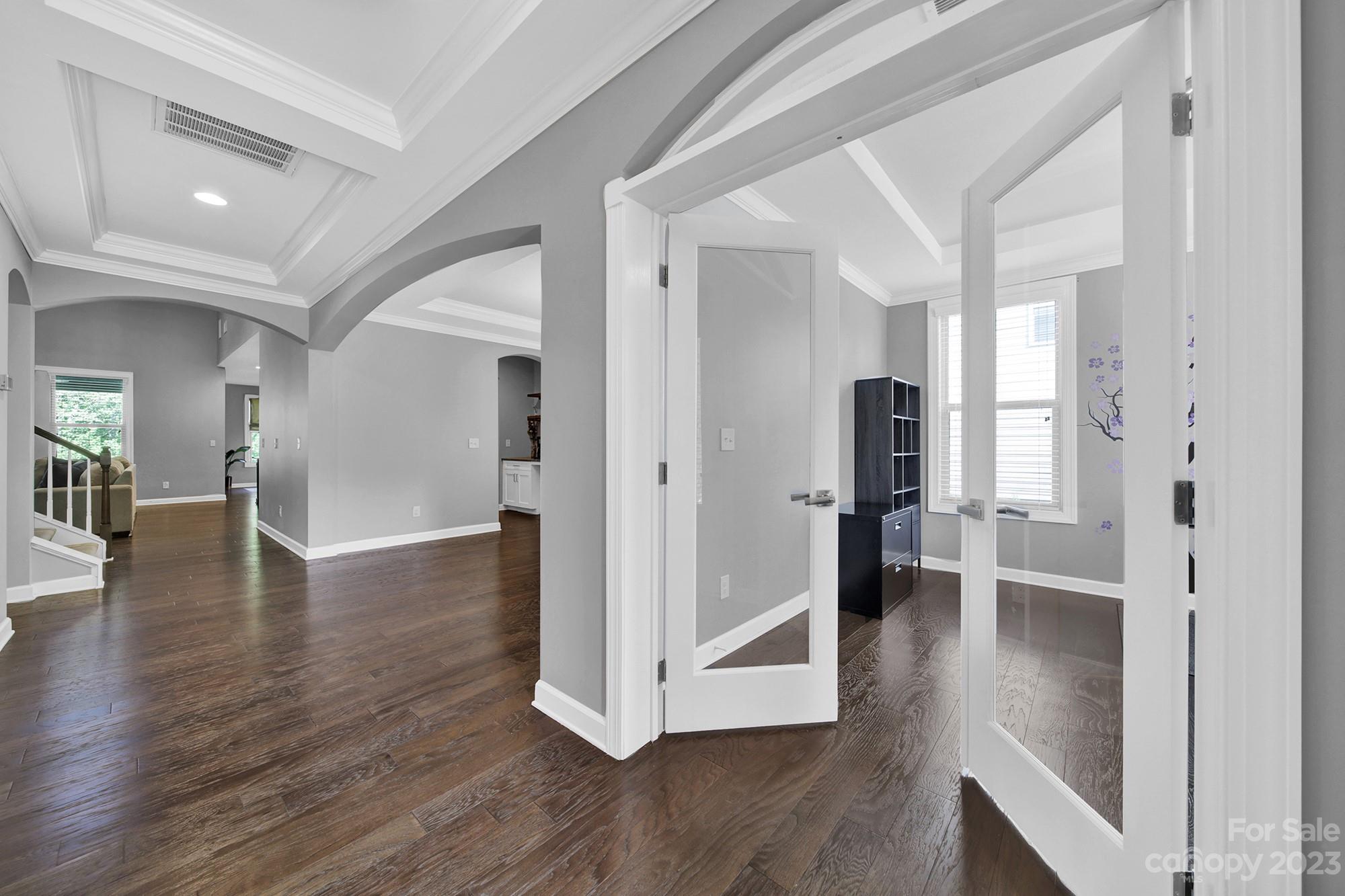 1516 Hazel Street Tega Cay, SC 29708 - Photo 14 of 48 a view of a hallway with wooden floor windows and a living room
