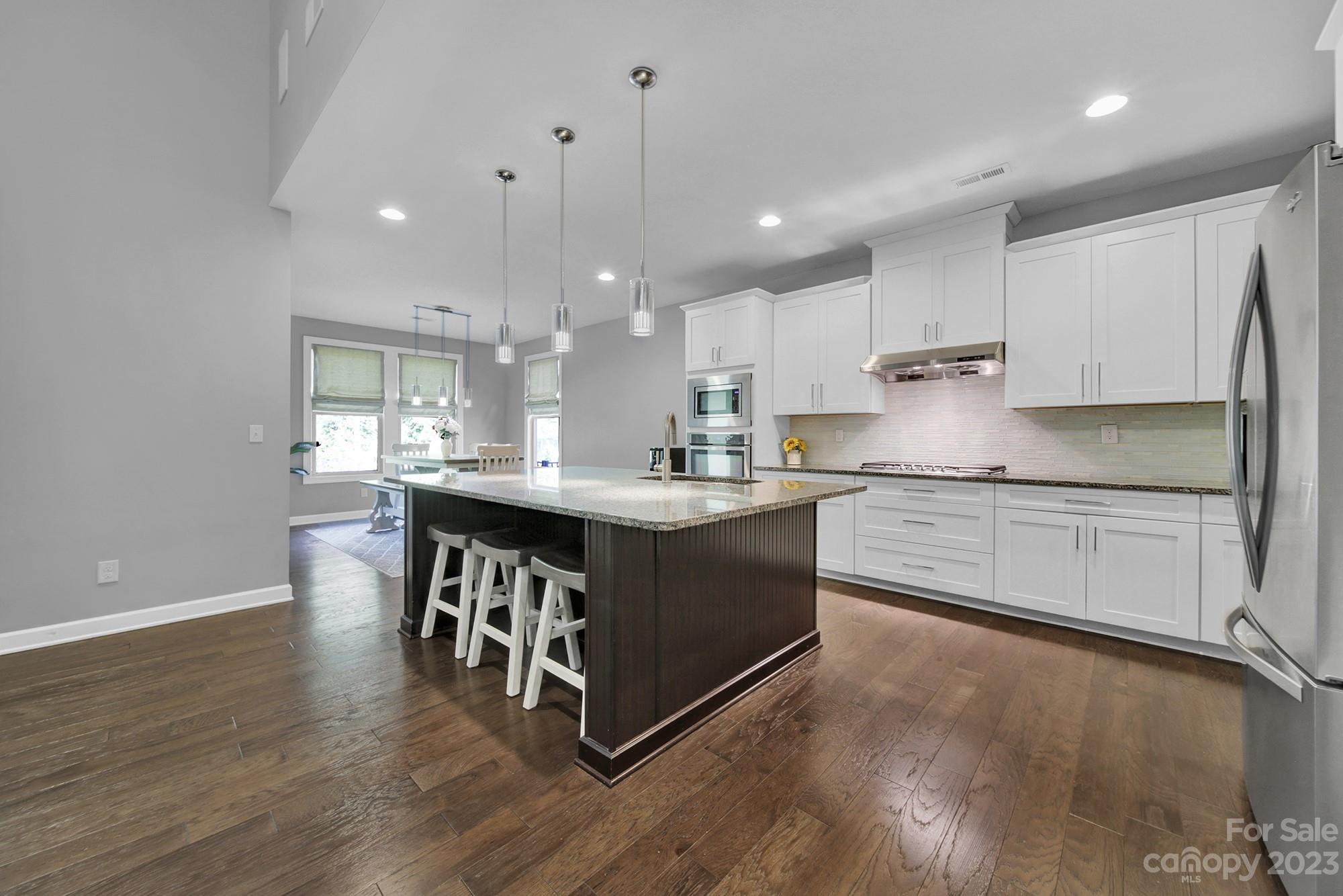 1516 Hazel Street Tega Cay, SC 29708 - Photo 19 of 48 a kitchen with stainless steel appliances granite countertop a stove a sink and a refrigerator