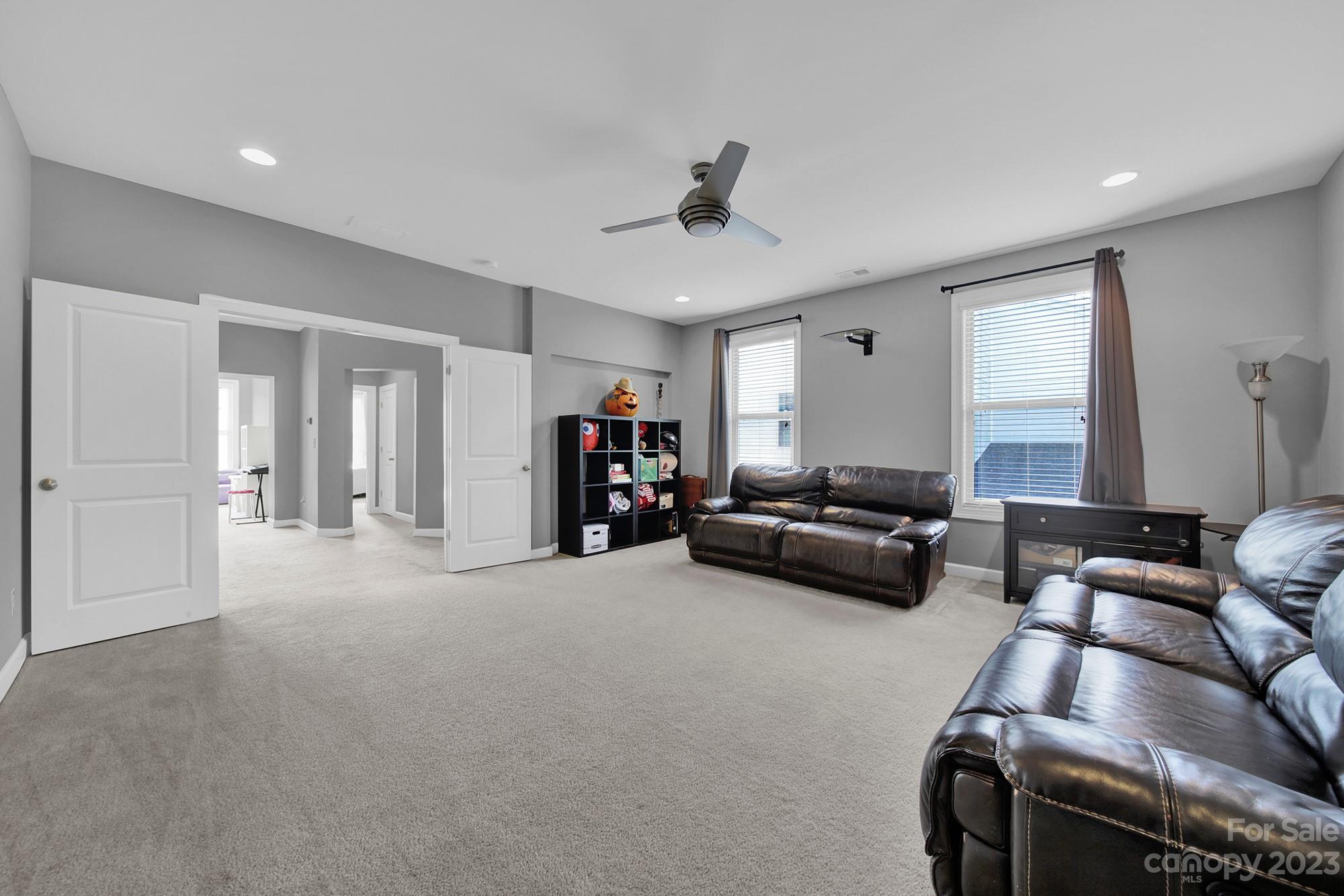 1516 Hazel Street Tega Cay, SC 29708 - Photo 36 of 48 a living room with furniture and a chandelier