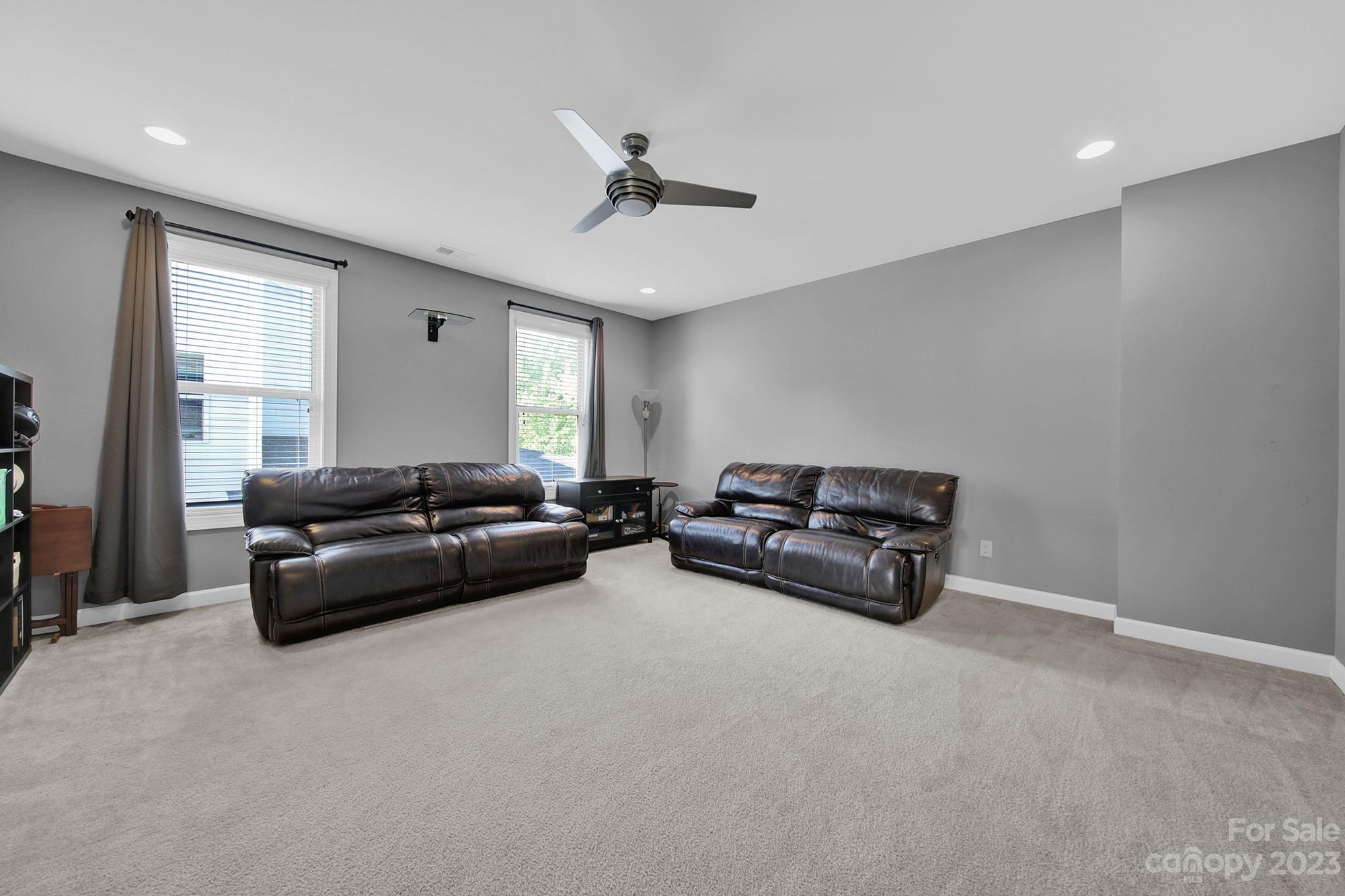 1516 Hazel Street Tega Cay, SC 29708 - Photo 37 of 48 a living room with furniture and a ceiling fan