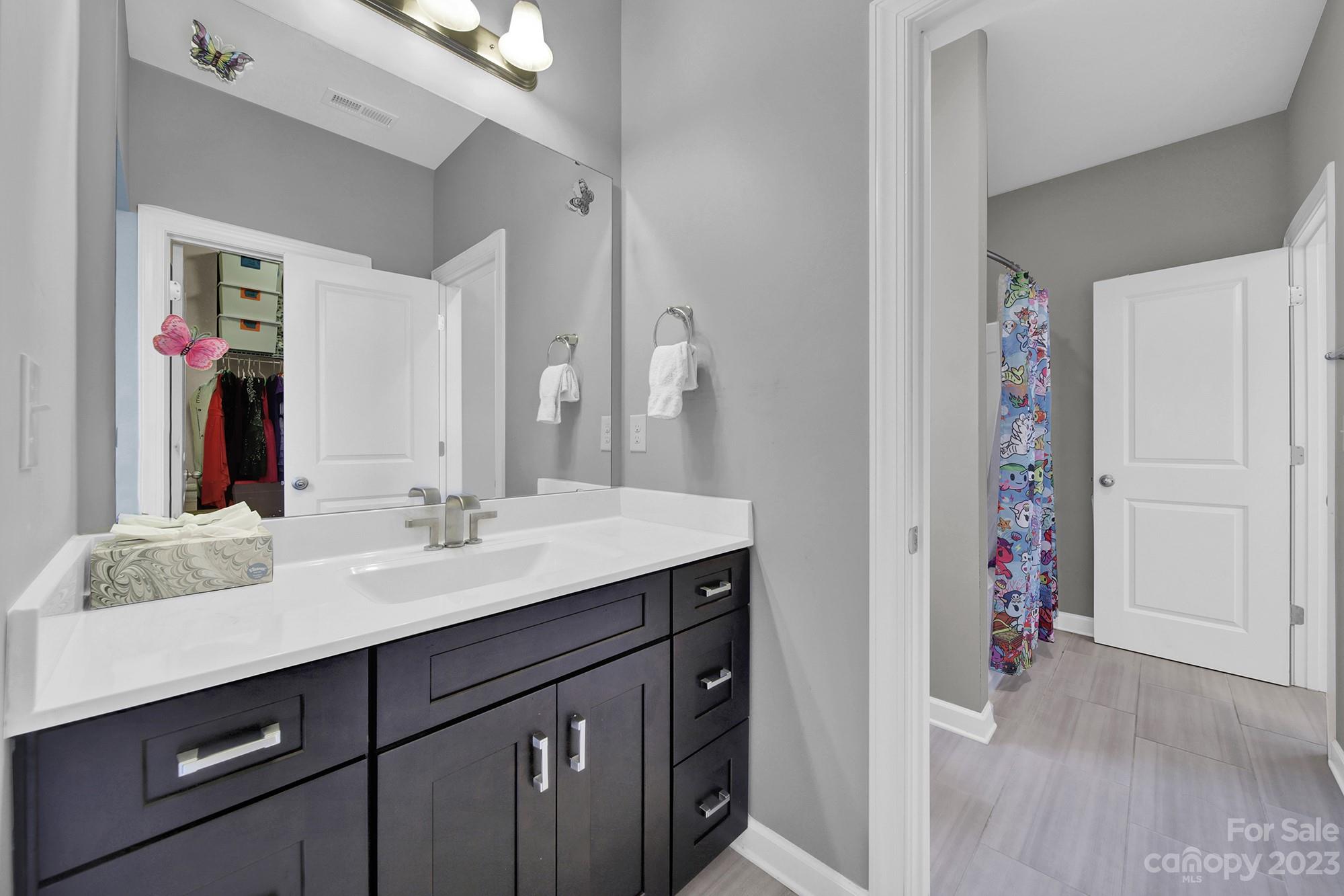 1516 Hazel Street Tega Cay, SC 29708 - Photo 42 of 48 a bathroom with a double vanity sink mirror and next to a window
