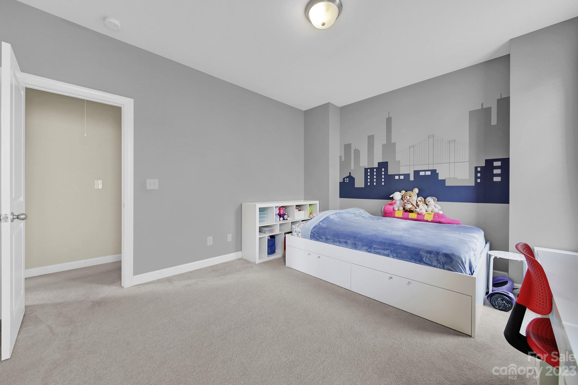 1516 Hazel Street Tega Cay, SC 29708 - Photo 44 of 48 a bedroom with a bed and a chandelier