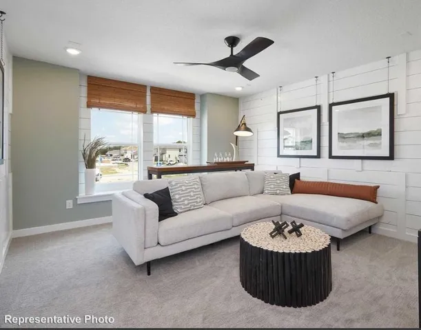 a living room with furniture and a large window