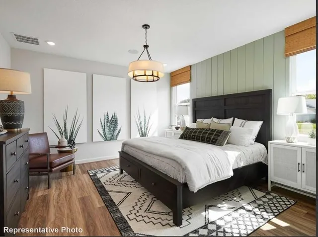 a bedroom with a bed and a chandelier