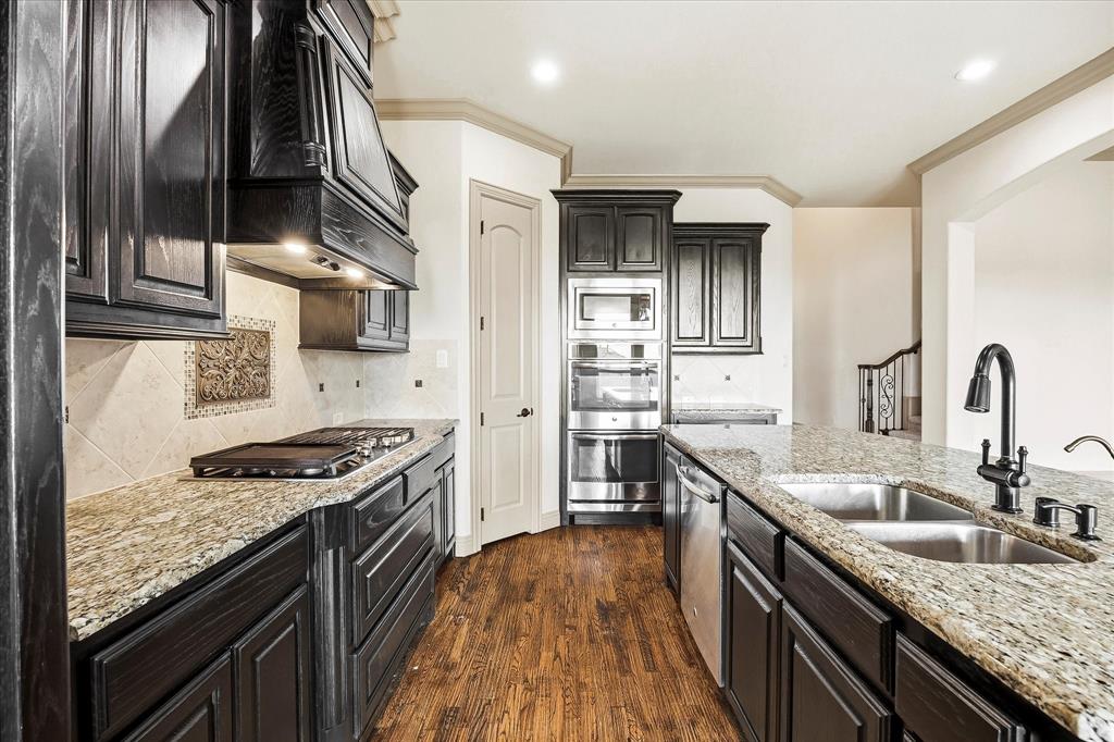 647 Gillon Way Rockwall, TX 75087 - Photo 16 of 40 Tons of custom cabinetry provides ample storage space for your kitchen necessities!
