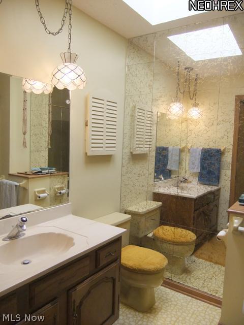 4293 Minor Road Akron, OH 44321 - Photo 14 of 21 The guest bathroom offers an oak vanity, skylight and tub with surround.