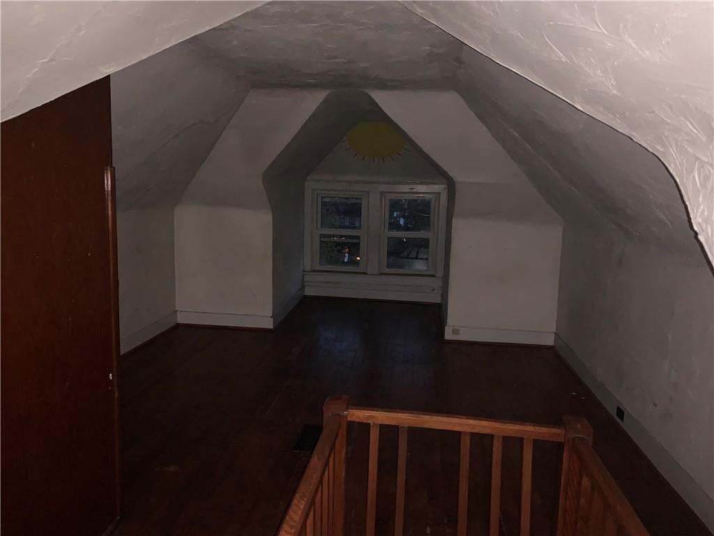 5 Carnegie Drive Midland, PA 15059 - Photo 14 of 18 a view of a hallway with wooden floor and a fireplace
