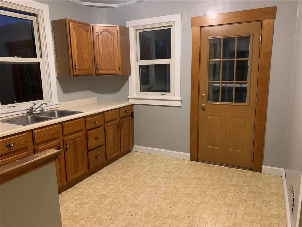5 Carnegie Drive Midland, PA 15059 - Photo 5 of 18 a kitchen with a sink window and cabinets