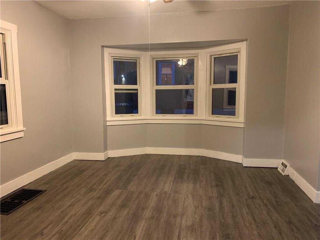 5 Carnegie Drive Midland, PA 15059 - Photo 6 of 18 a view of an empty room with wooden floor and a window