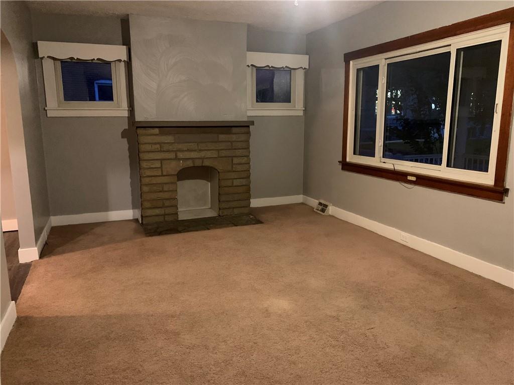 5 Carnegie Drive Midland, PA 15059 - Photo 8 of 18 a view of an empty room with a fireplace