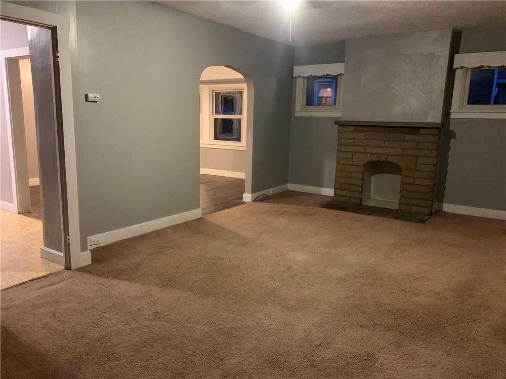 5 Carnegie Drive Midland, PA 15059 - Photo 9 of 18 an empty room with windows and fireplace